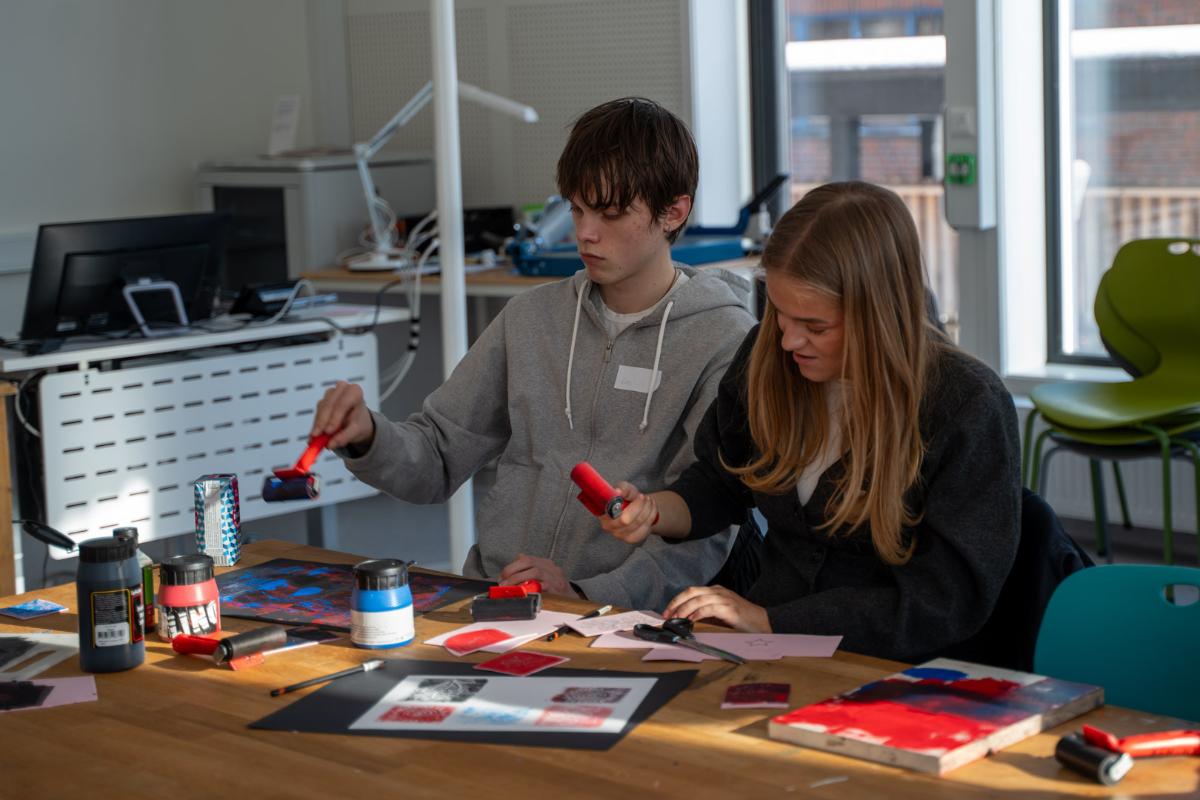 Gutt og jente maler og lager trykk i formingstime 